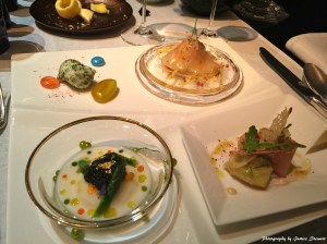 First Service From top left clockwise: Main lobster in a thinly sliced turnip with sweet and sour dressing; Carpaccio of foie gras and potatoes covered with black truffle shavings; and White asparagus frivolity with essentials oils and Osetra Caviar